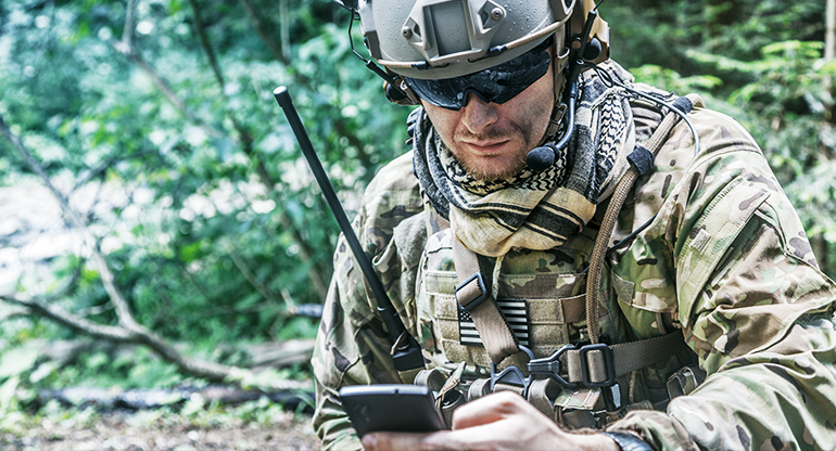 Warfighter on the front line listening to instructions over radio